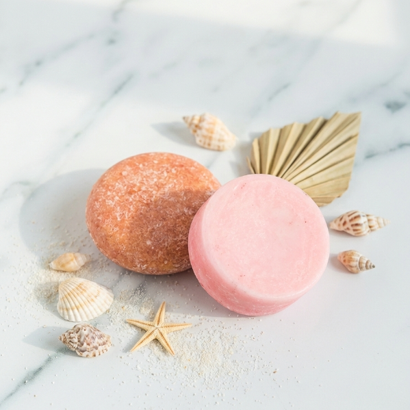 Beach Vibes hair care duo featuring tropical-scented shampoo and conditioner bars in pink and yellow for a vacation-ready glow.