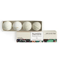 A premium bath bomb set featuring four handcrafted white bath bombs in an open gift box with Humble Botanics branding on a clean white background.